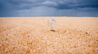 Lightbulb in sand