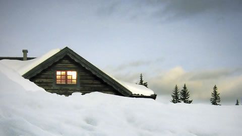 Image of a snowed-in cabin
