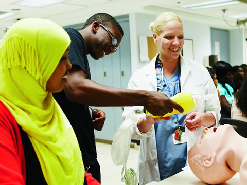 Maryan Issa (left) and Malik Paris learn about intubation from surgical resident Emily Partridge
