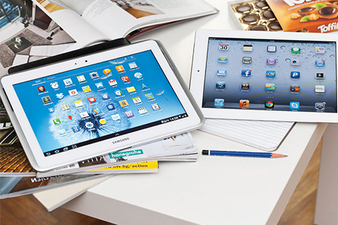 Photo of iPads on a desk with a pencil.