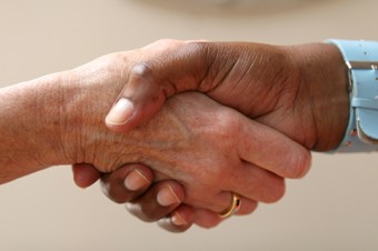 Photo of two hands in a handshake.