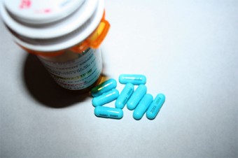 Photo of pills and a bottle.
