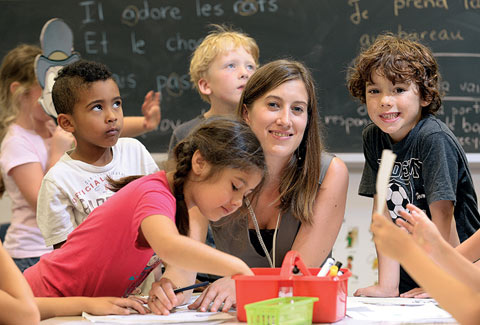 Photo of Tamara Mitchell with young students.