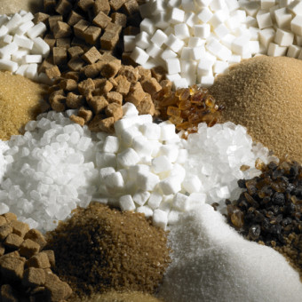 Photo of many types of sugar in piles.