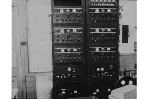 Black and white photo of Hydra radio equipment in two columns of black rectangular boxes with dials, stacked one on top of another