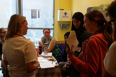 Student volunteers and preceptors discuss the day’s cases at the IMAGINE clinic. Credit: Jelena Damjanovic