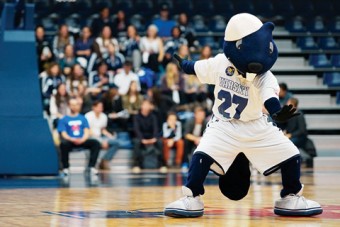 Photo of UofT mascote, True Blue at a sports game.