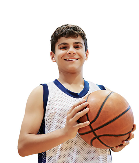 Close-up photo of a teenged boy in a tank top holding a basketball