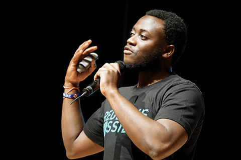 Photo of Michel Chikwanine speaking into a microphone