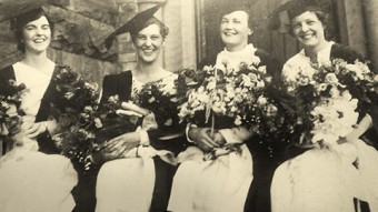 Old photo of Elizabeth Cranston and three other women sitting down in robes holding flowers