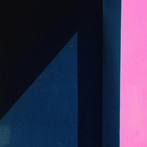Photo of blue, black and pink surfaces forming geometric shapes