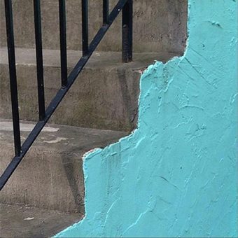 Photo of concrete steps with the side painted in aqua blue