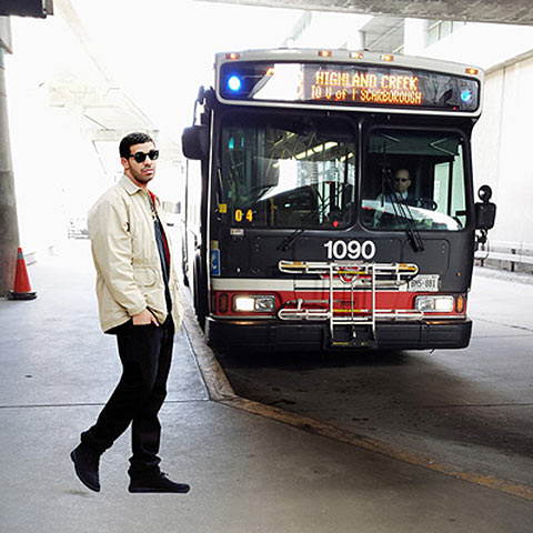 Photo of Drake waiting for an approaching bus at UTSC