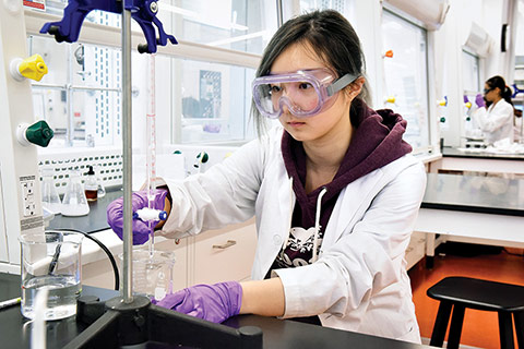 Photo of a student in the lab conducting an experiment