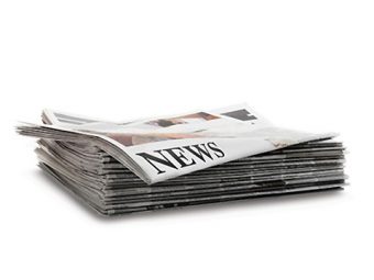 Photo of a stack of newspapers with the headline "NEWS" appearing on the front page at the top