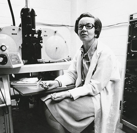 Photo of Ursula Franklin in a lab surrounded by equipment