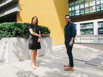 Photo of Prof. Shauna Brail and Prof. Mauricio Quiros-Pacheco standing in front of a building