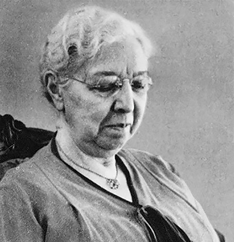 Headshot of Margaret Addison in reading glasses.