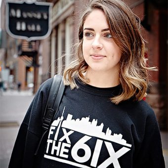 Close up shot of Deanna Lentini wearing a sweater with the words "Fix The 6ix"