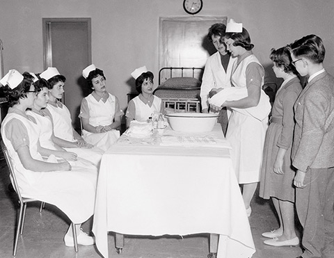 Tub time for baby: Nurses teach U of T students how to care for a newborn. Photo: University of Toronto Archives, 2010-40-8MS.