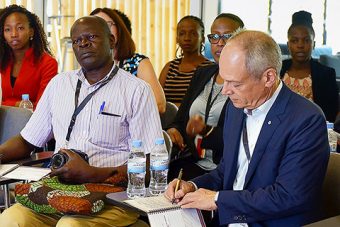 U of T president Meric Gertler (right) meets students at the African Institute for Mathematical Sciences in Rwanda.