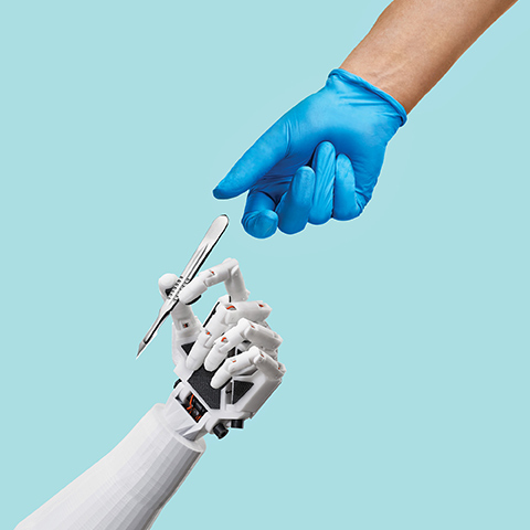 A surgeon's hand reaching for a scalpel, being offered by a robotic hand