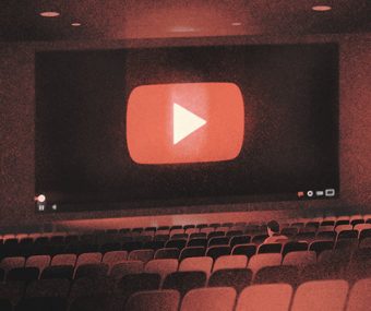 Illustration of seats in a movie theatre with the screen showing the "play" arrow click button at the start of YouTube videos.