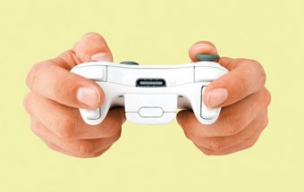 Photo of a pair of hands operating a video game controller.