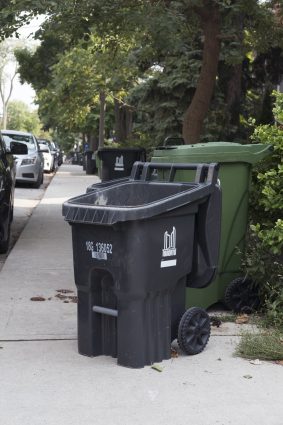 A City of Toronto garbage can blocking the sidewalk