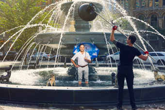 Claude Cormier stands in the dog fountain he designed in Berczy Park, Toronto