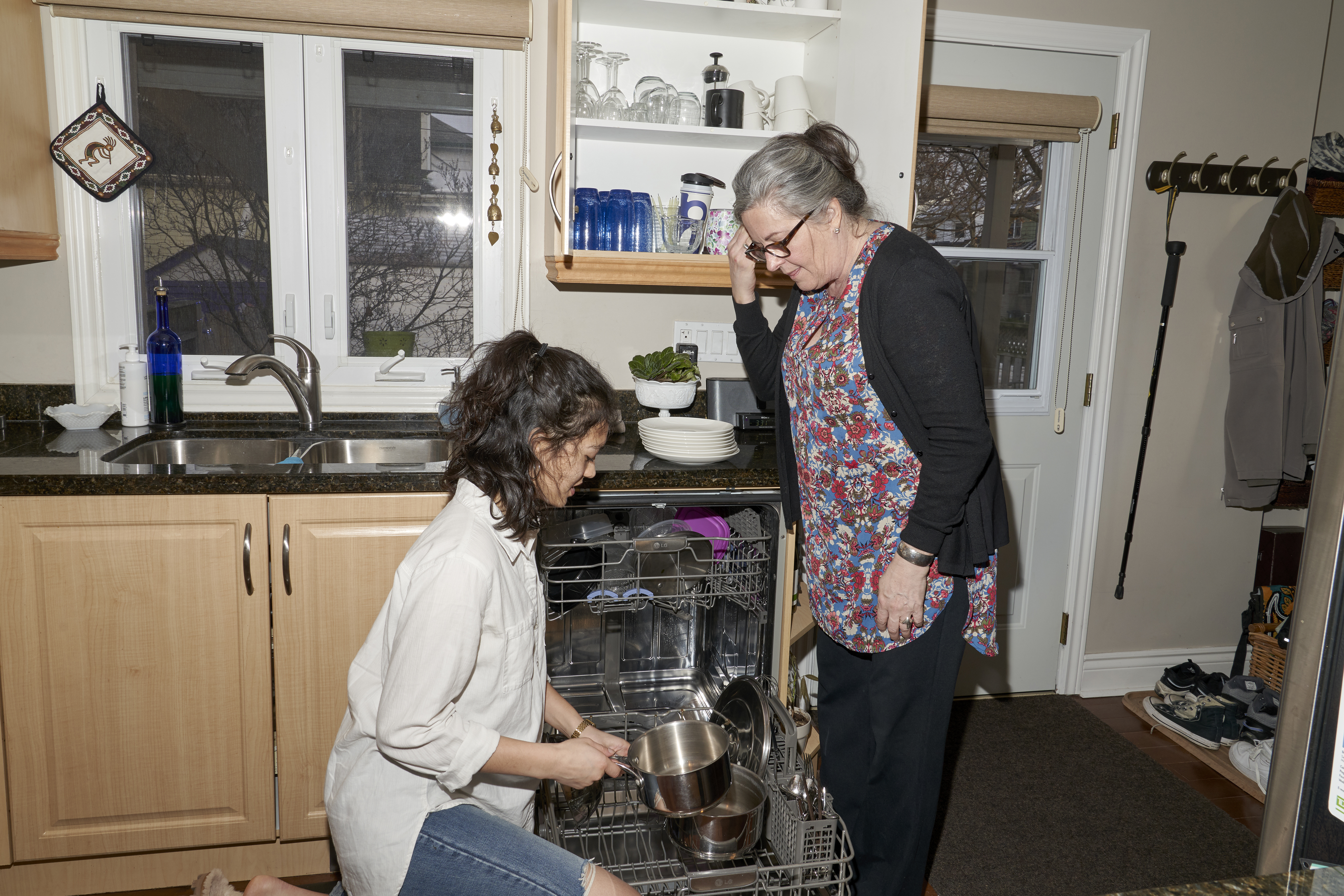 18-year old U of T student Zoe Butcher helps Catherine Finlayson, 61 empty the dishwasher. The two roommates are part of the Toronto HomeShare Pilot Project where university students are paired with senior-citizens who have a spare room in their homes. Students are expected to help out around the house doing chores and light housework in return for subsidized rent