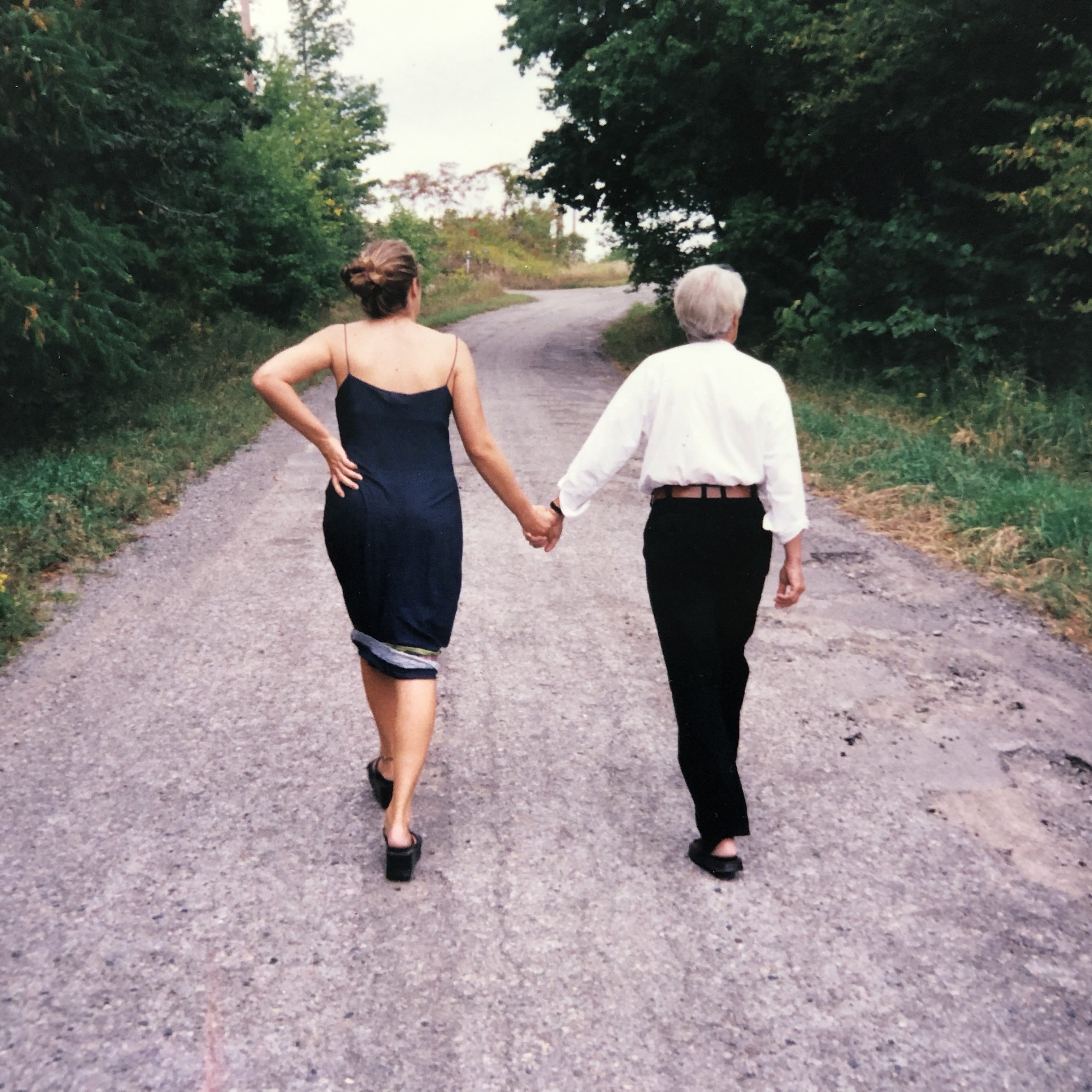 Wittmann and her father walk down a road away from the viewer