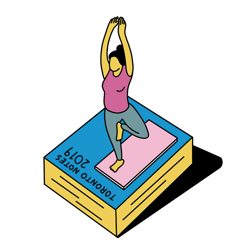 A woman doing yoga on a mat on top of a giant-sized Toronto Notes 2019 book