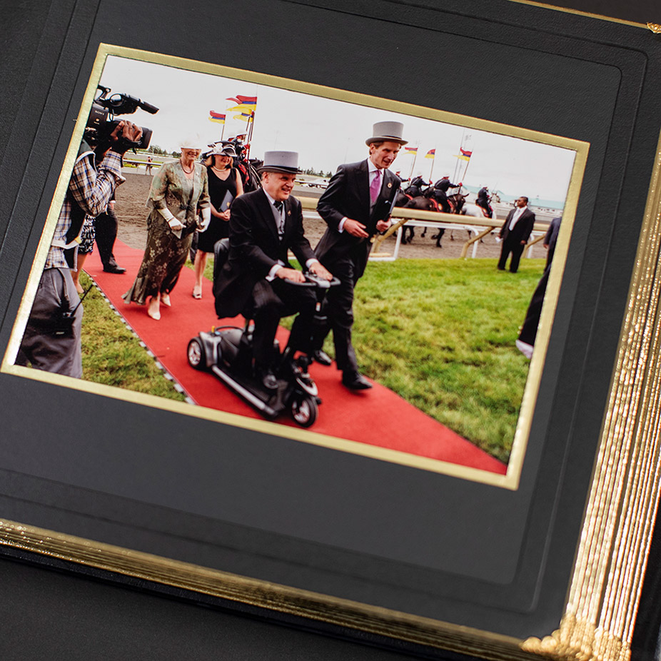 Photo album open to a photograph of David Onley on the red carpet at the Queen's Plate
