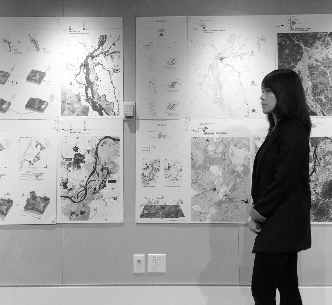 Shaine Wong looking at geological maps on a wall