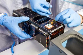 Closeup of Kepler satellite being worked on by researchers