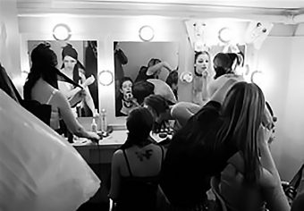 Cast members of The Rocky Horror Show in a dressing room preparing for a midnight performance at Hart House