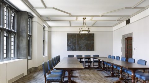 The Hart House south dining room, with chairs and tables and a piece of art hanging on the wall