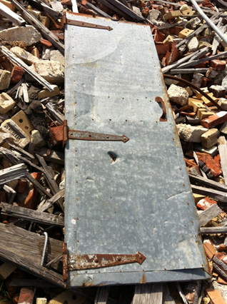 Steel door lying on top of rubble