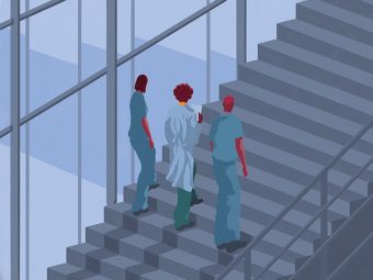 A doctor and two medical students walking up a staircase