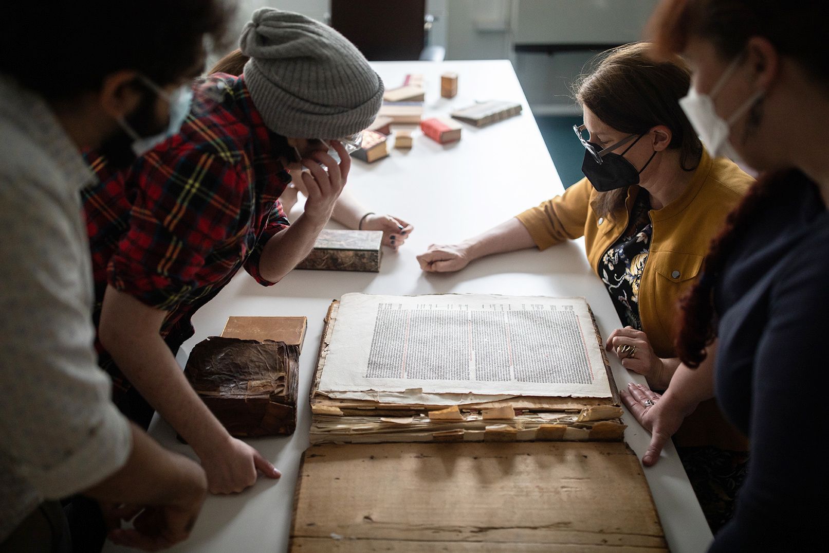 Prof. Alexandra Gillespie and PhD students examine an ancient text