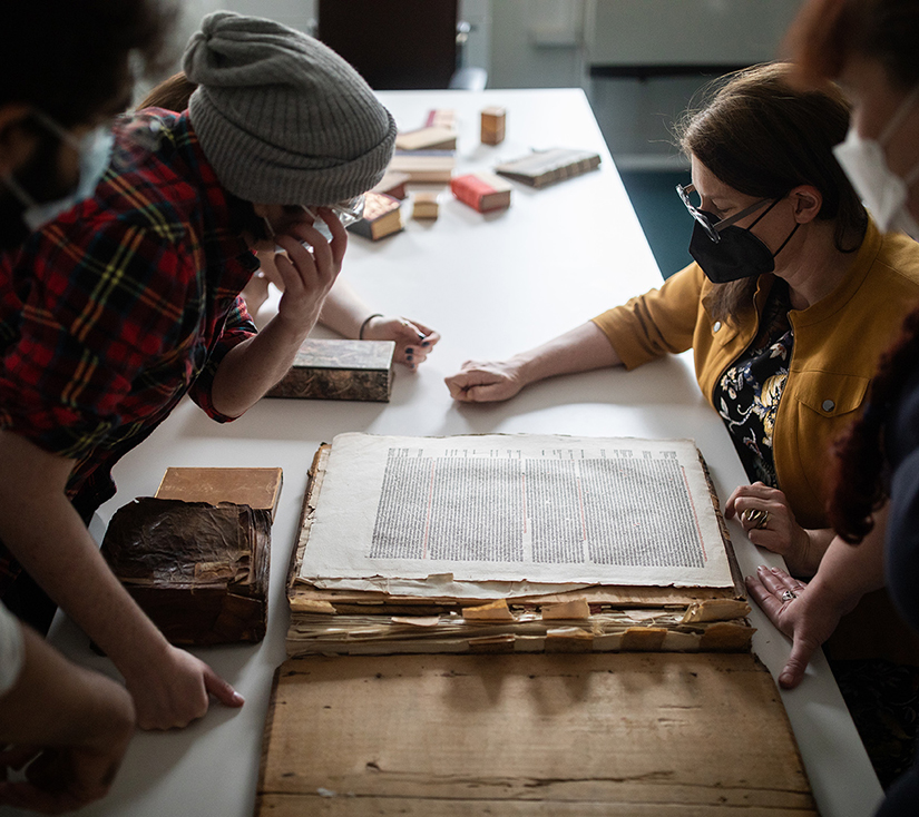 Prof. Alexandra Gillespie and PhD students examine an ancient text