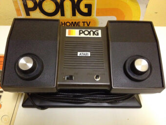 Home console for Atari's Pong, with two dials on either side, a power switch and start button in the centre, and the Pong logo at the top