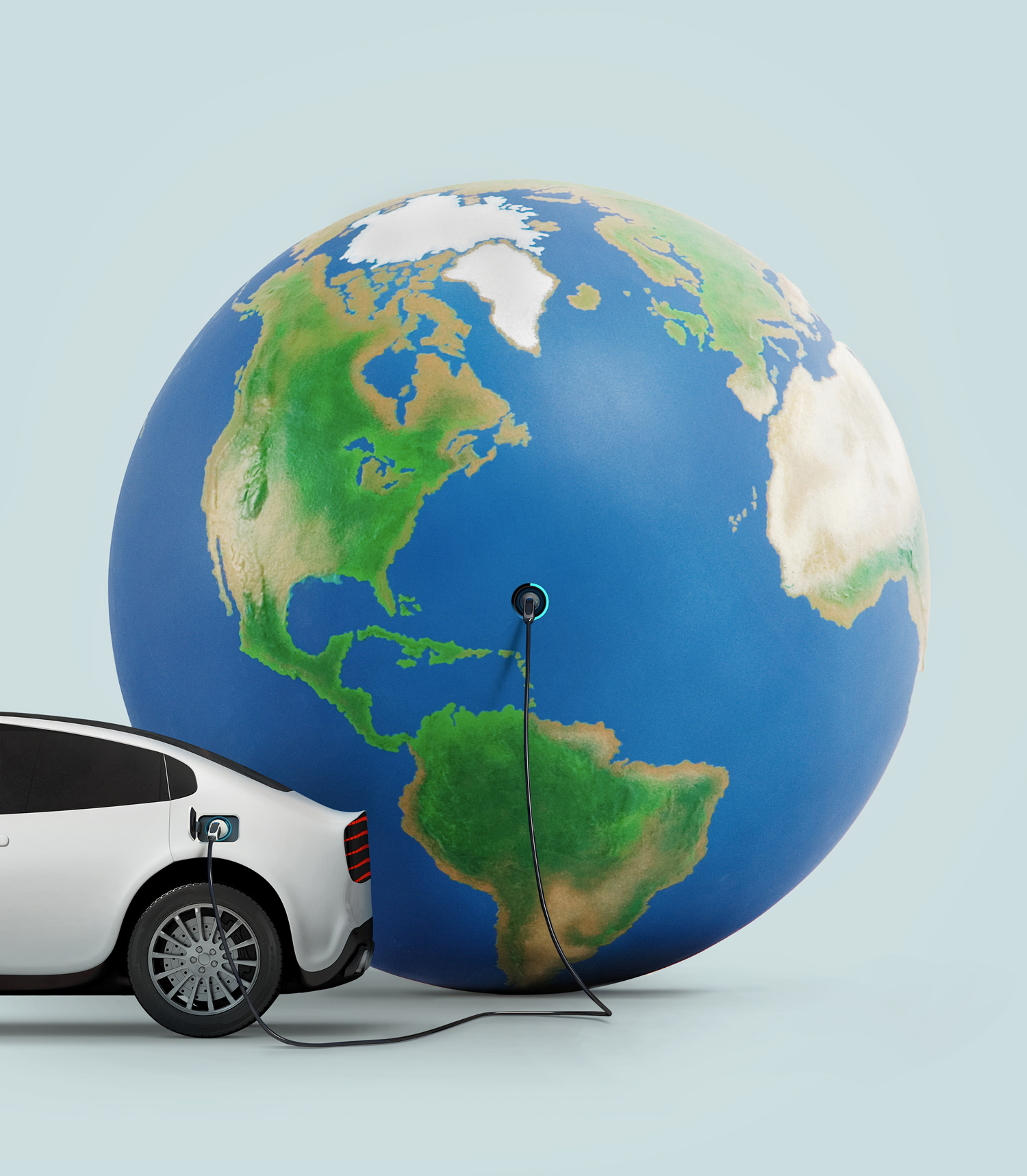 The back half of an electric car, with its charging cable plugged into a large inflated Earth globe