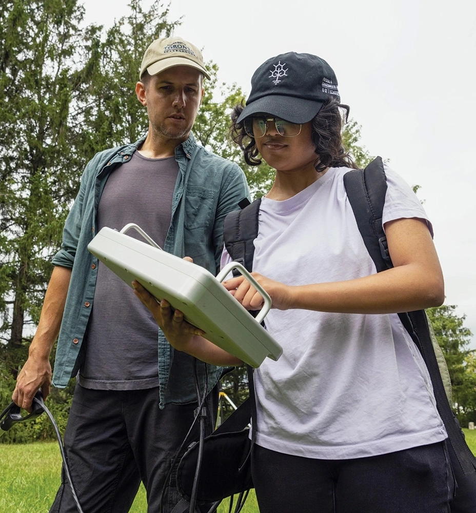 Two researchers are looking at a monitor