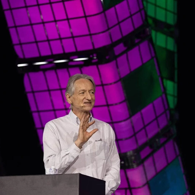 Professor Emeritus Geoffrey Hinton speaking at a podium