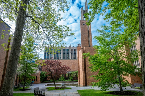 View of the central quad courtyard in Massey College and the surrounding buildings and trees