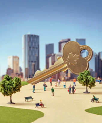 Models of tiny people, trees and benches in a park setting, with a giant, copper, "Made in Canada" key hovering above. In the background is a cityscape.